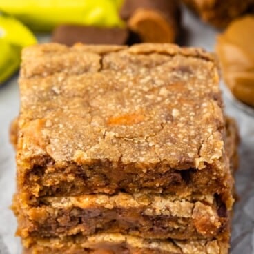 stacked blondies with butterfinger in the back.