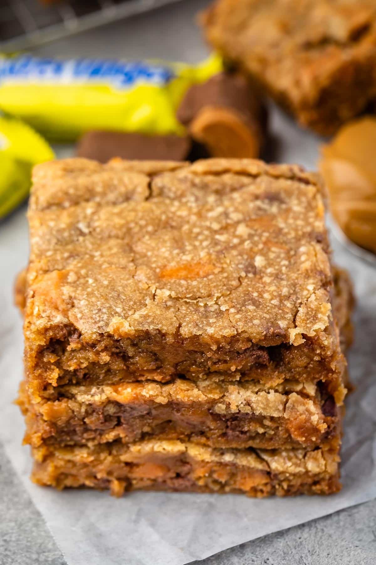 stacked blondies with butterfinger in the back.