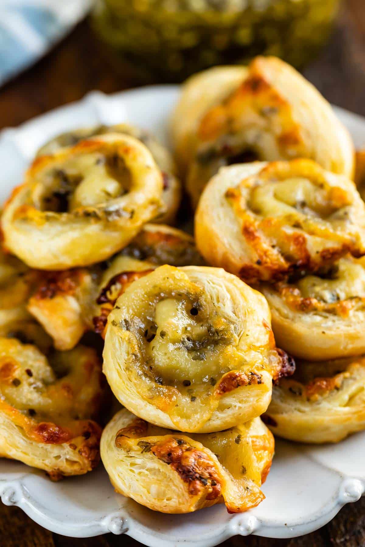 pinwheels rolled up with green pesto sitting on a grey plate.