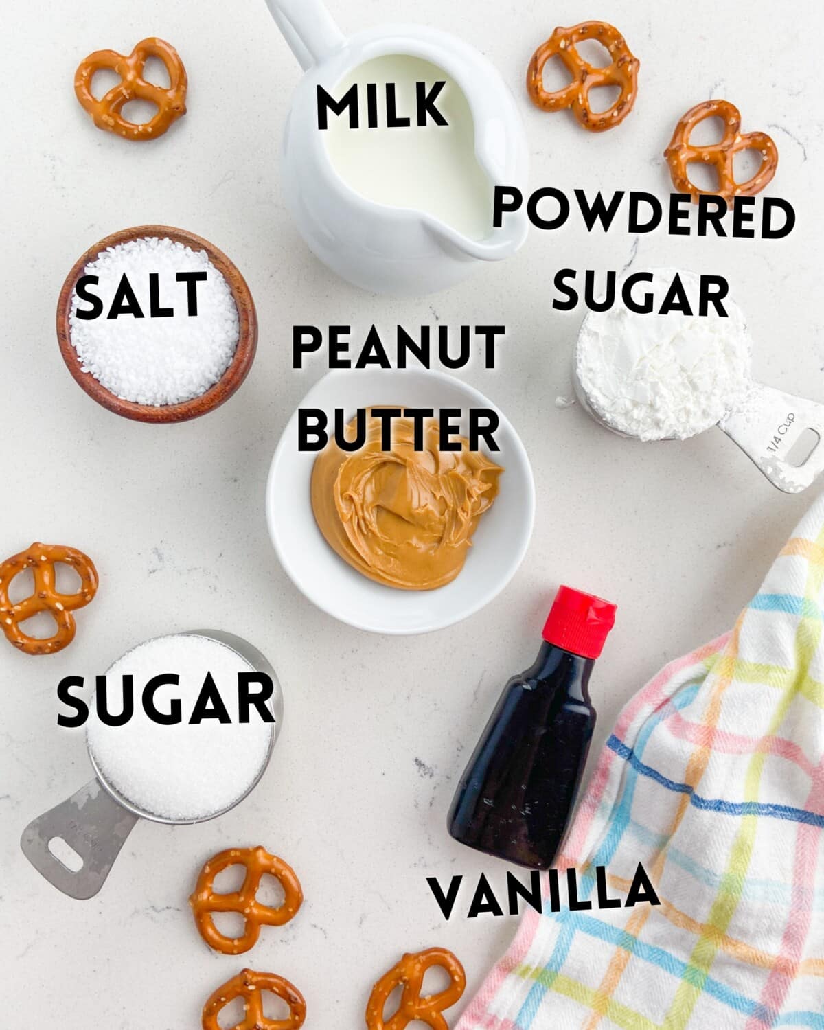 ingredients of pretzel peanut butter pie laid out on marble counter.