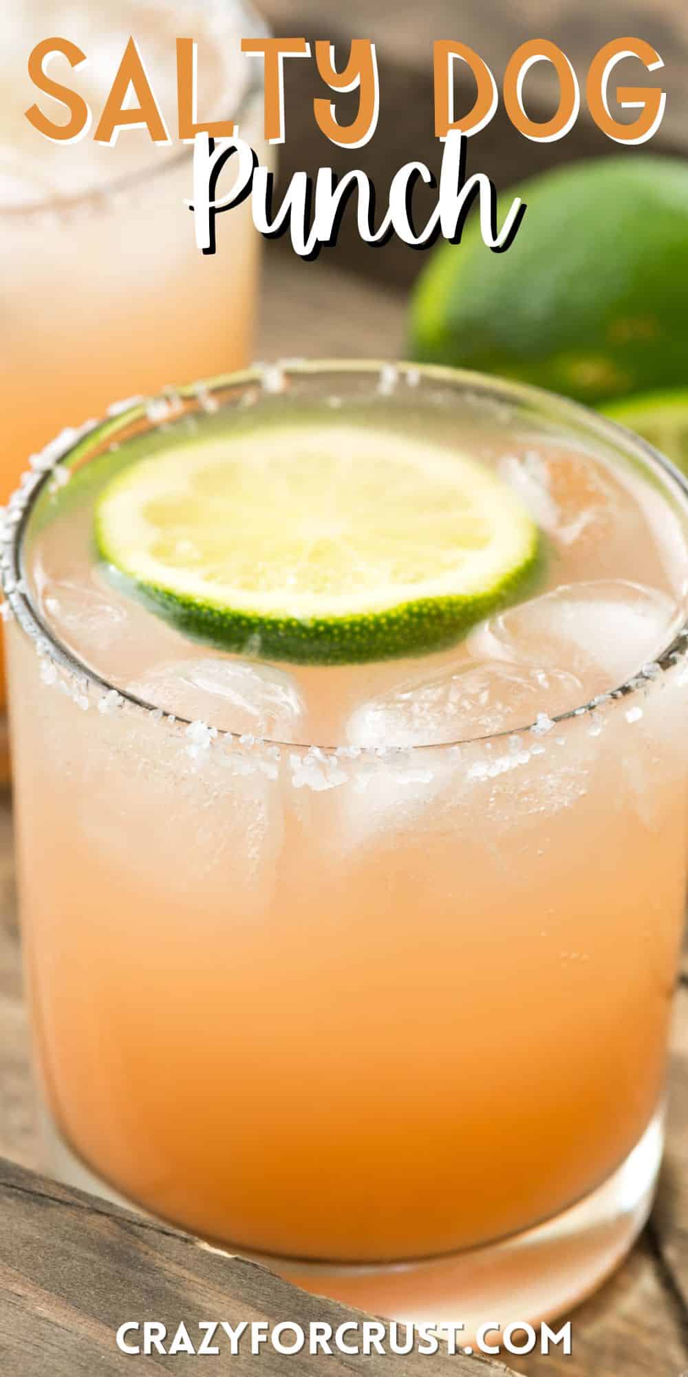 peach colored drink in a short clear glass with a lime slice in the drink with words on the image.