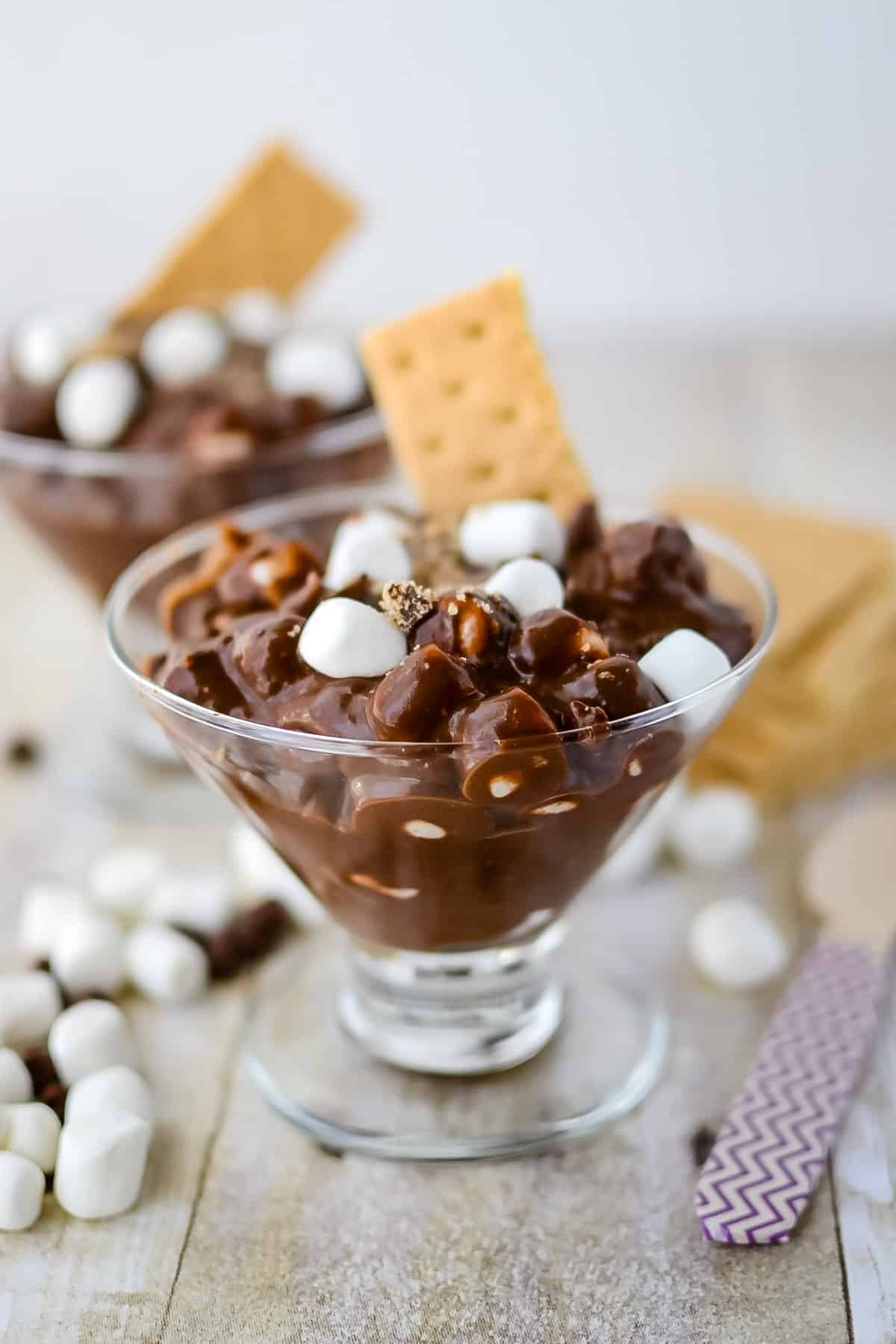 brown s'mores pudding with mini marshmallows and graham cracker in it.