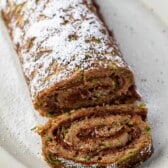 sliced cake roll with chocolate filling and powdered sugar sprinkled on top.