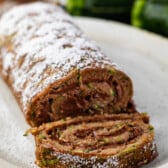 sliced cake roll with chocolate filling and powdered sugar sprinkled on top.