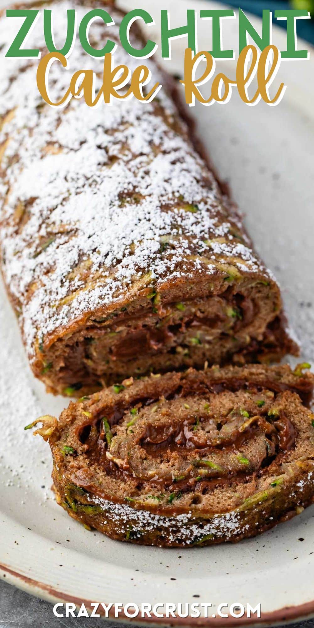 sliced cake roll with chocolate filling and powdered sugar sprinkled on top with words on the image.