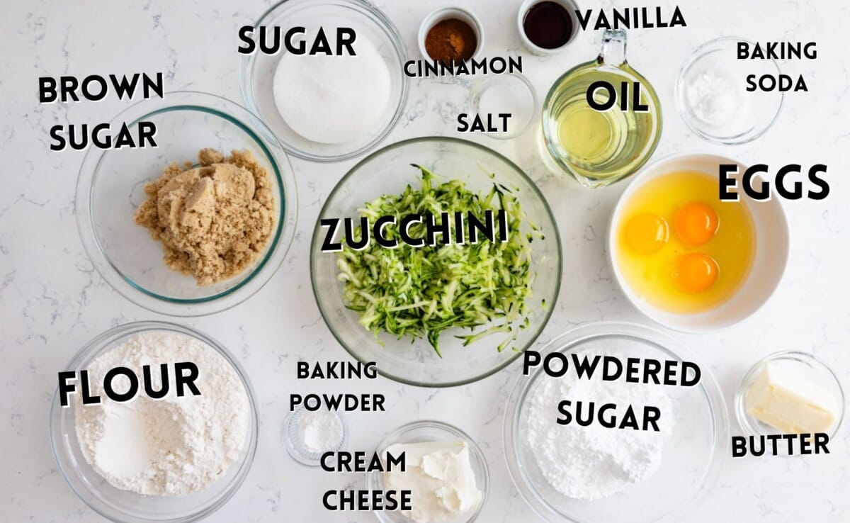 ingredients in zucchini cake laid out on a marble counter.
