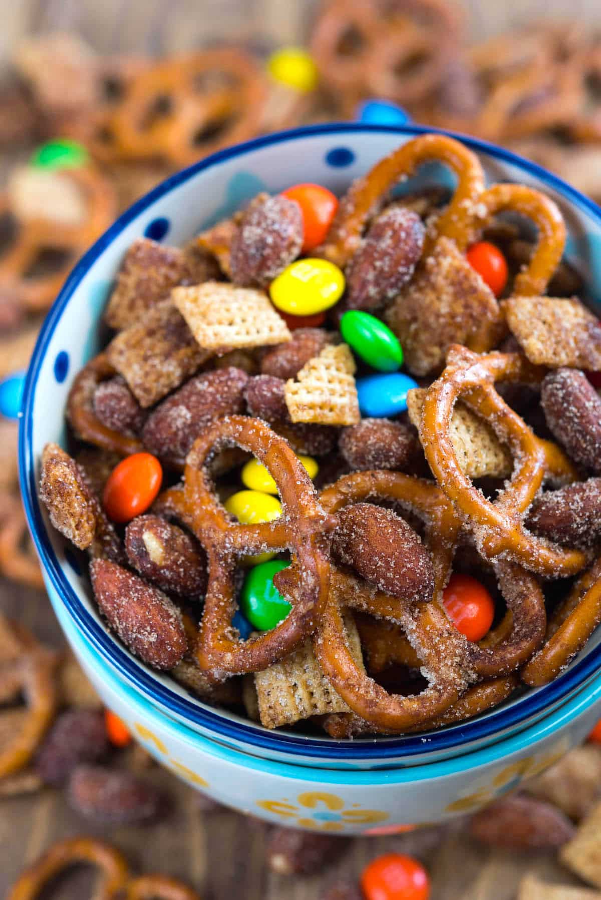 bowl of snack mix with pretzels and m&ms.