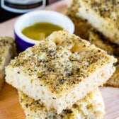 staked square slices of bread with oil and herbs on top.