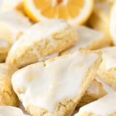 stacked lemon scones with vanilla icing on top.