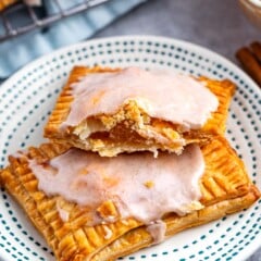 pop tarts on a white plate with one pop tart cut in half revealing apple pie filling.