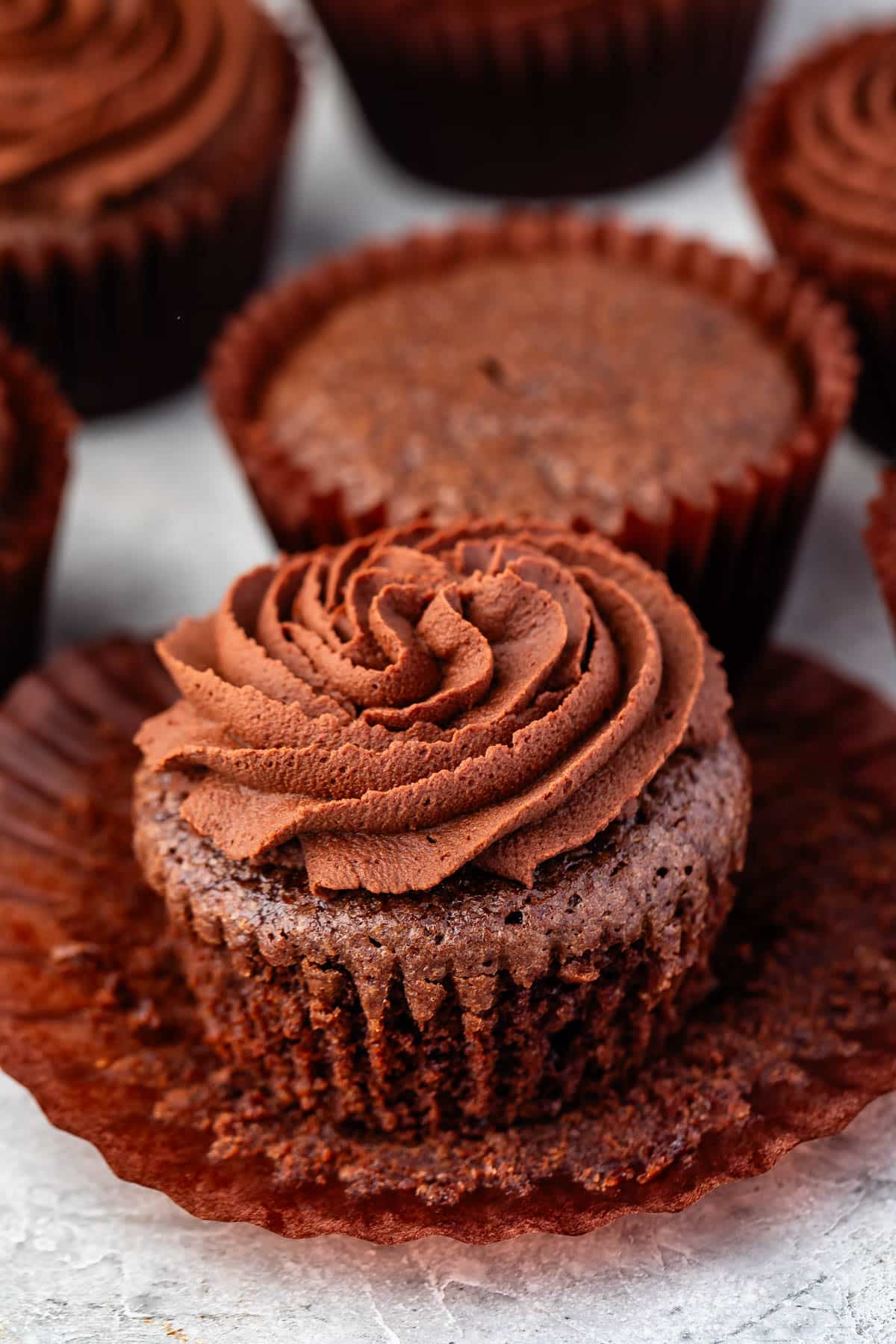 brownie cupcake with brown frosting.
