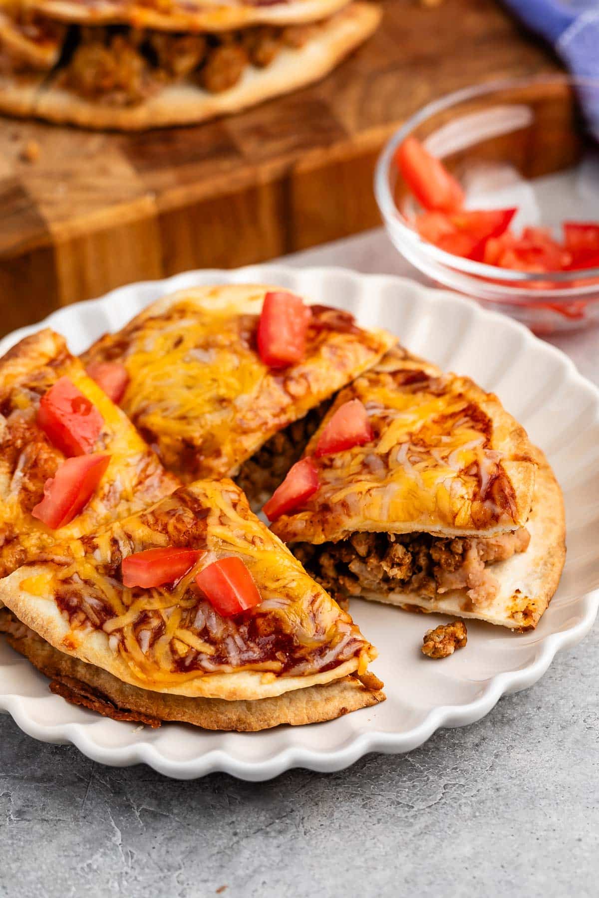 sliced mexican pizza on a white plate.