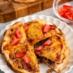 sliced mexican pizza on a white plate.