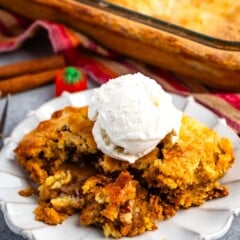 dump cake on a grey plate with ice cream scoop on top.