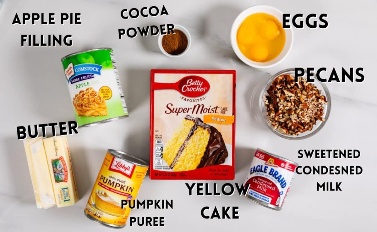 ingredients in pumpkin dump cake laid out on marble counter.