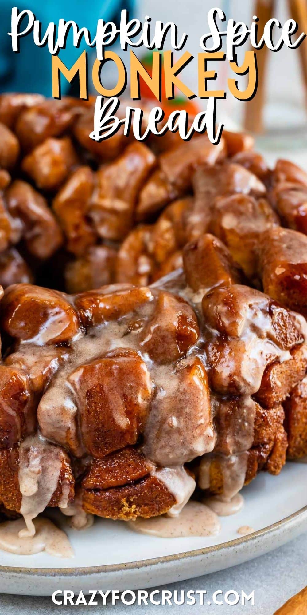 monkey bread on a grey plate with icing dripped over the top with words on the image.