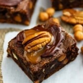 brownies with caramel and a pecan on top.