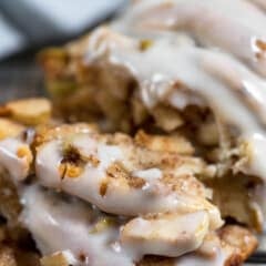 sliced apple fritter bread with white icing on top.