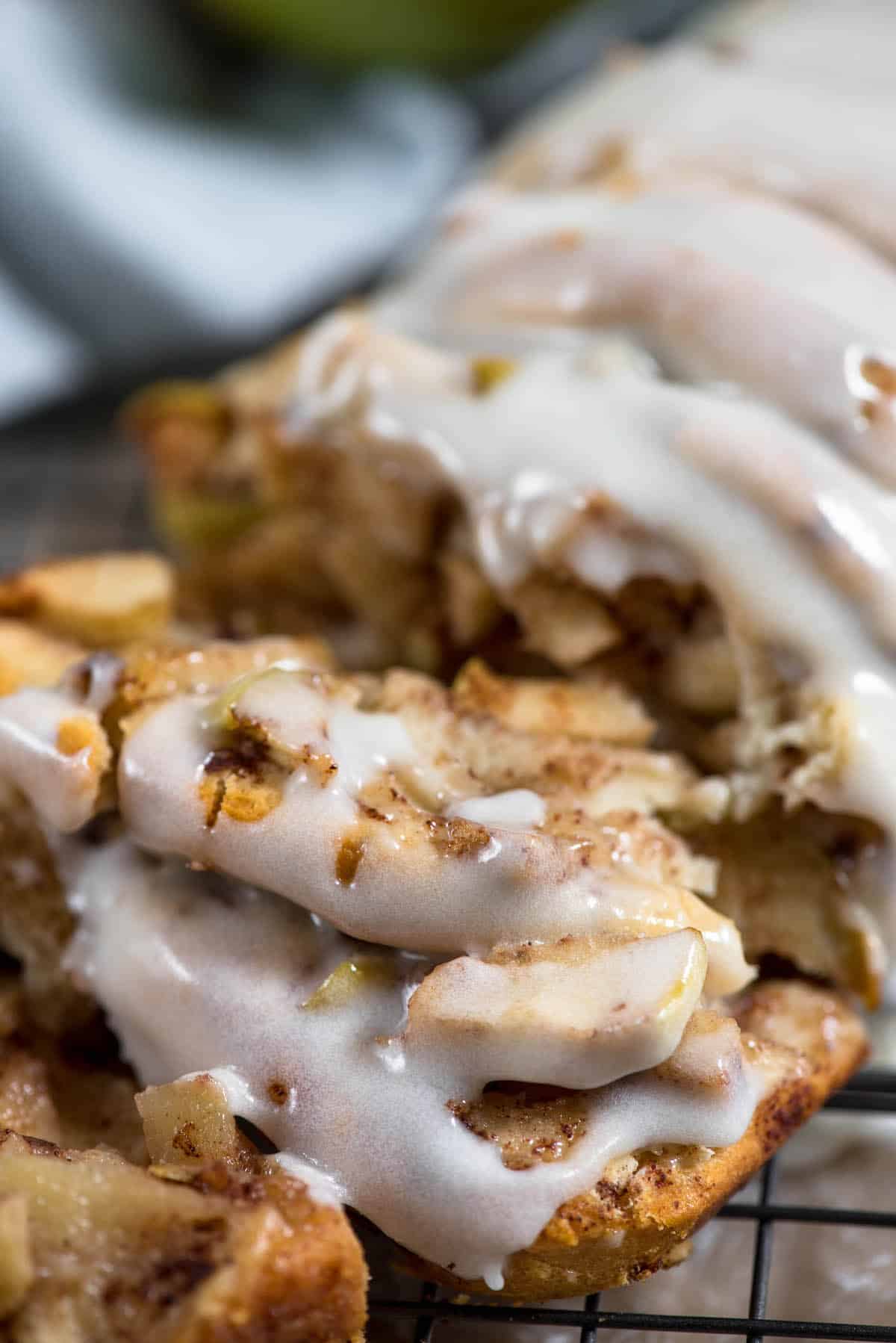 sliced apple fritter bread with white icing on top.