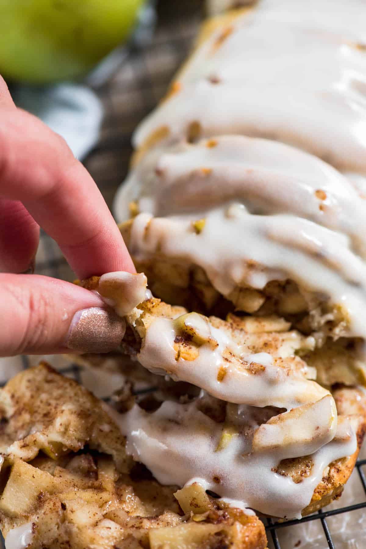 sliced apple fritter bread with white icing on top.