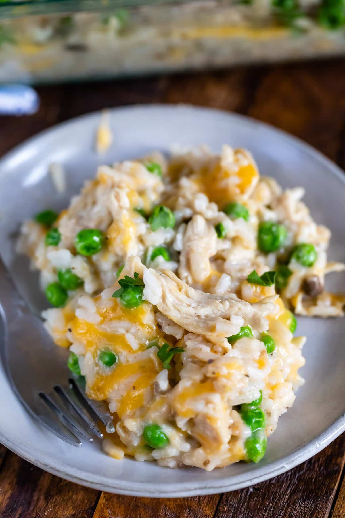 chicken and rice casserole on a grey plate next to a fork.