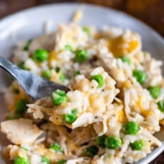 chicken and rice casserole on a grey plate next to a fork.