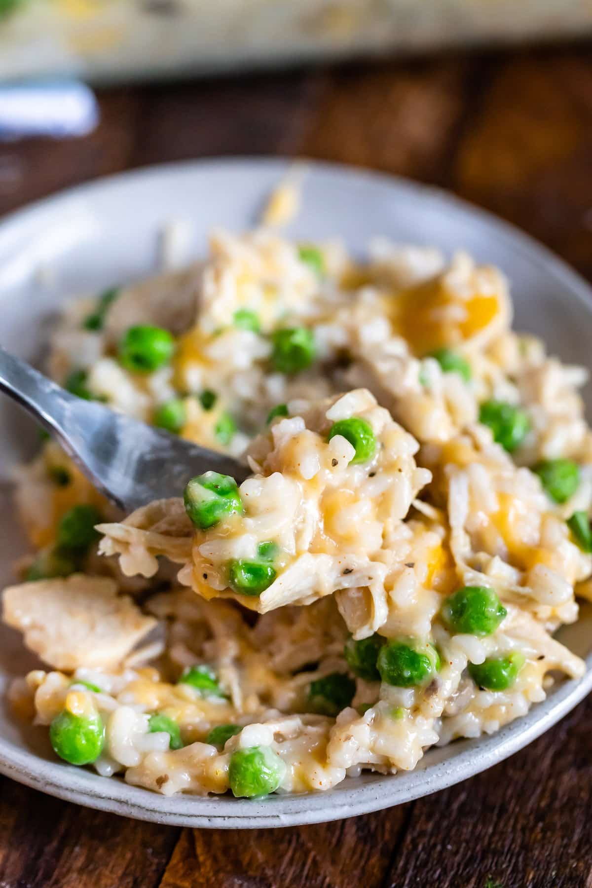 chicken and rice casserole on a grey plate next to a fork.