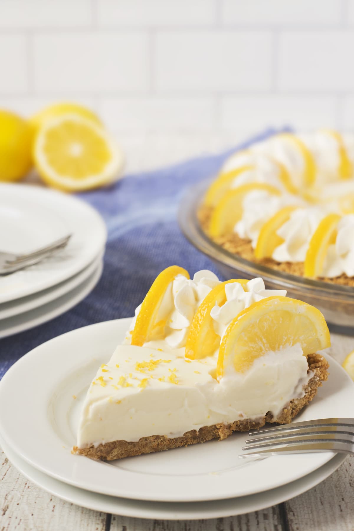 lemon pie with lemon slices and whipped cream on top.