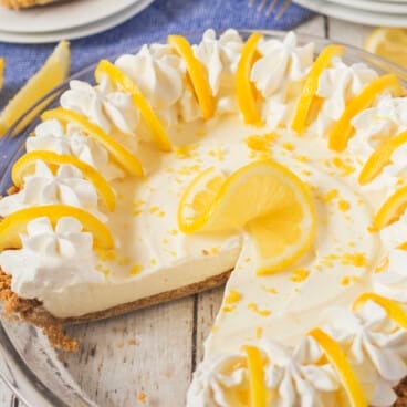 lemon pie with lemon slices and whipped cream on top.