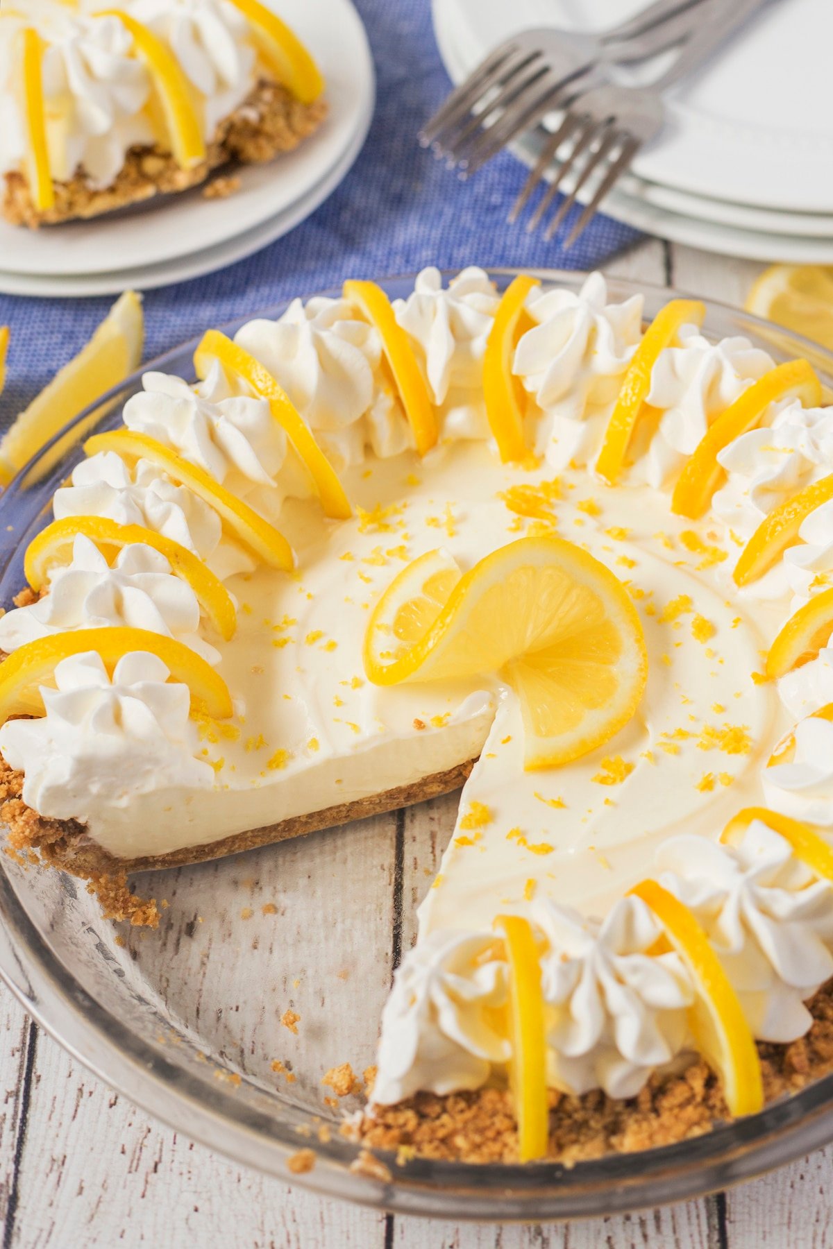 lemon pie with lemon slices and whipped cream on top.