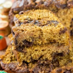 sliced pumpkin bread with chocolate chips baked in on a cutting board.