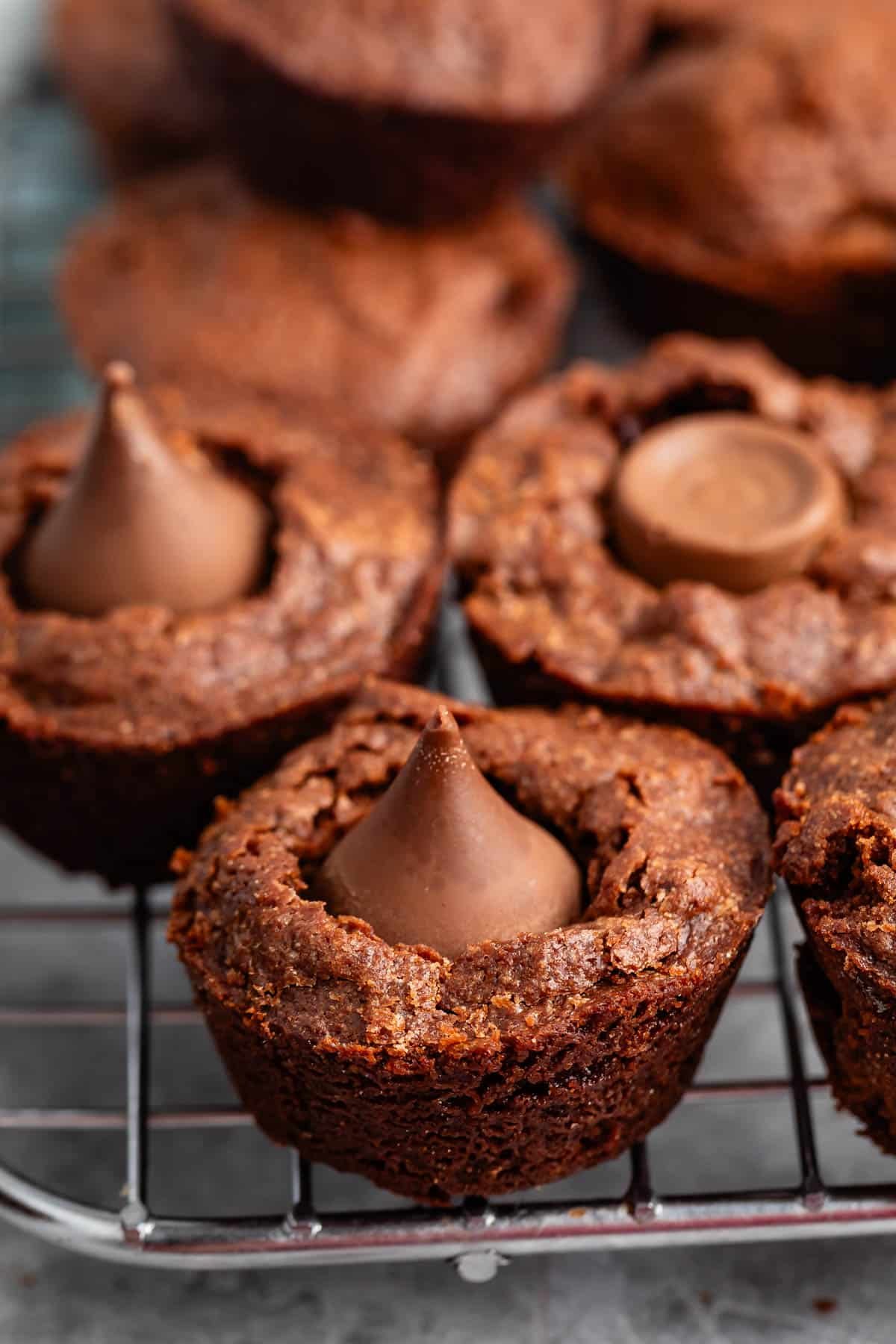 brownie bites layered on a drying wrack with chocolate in the top.