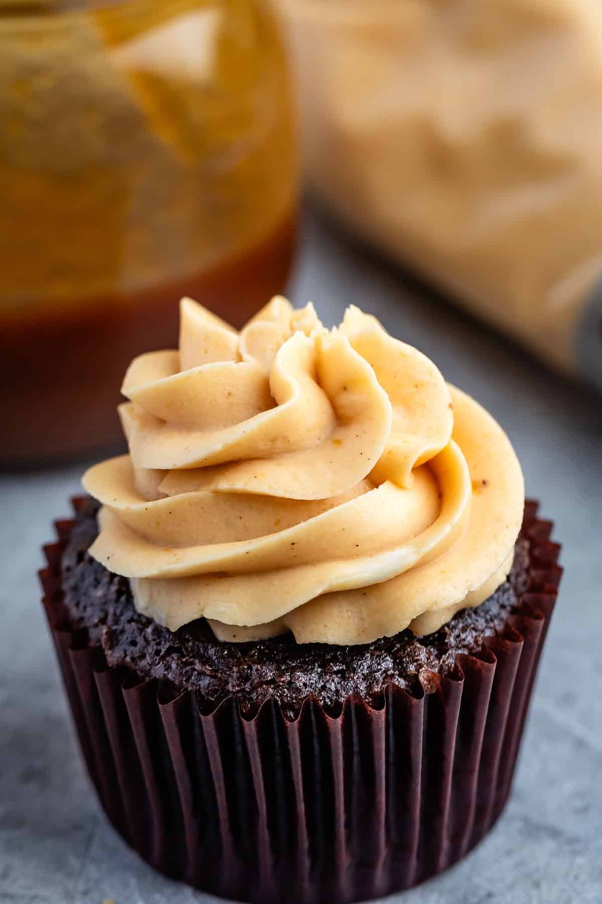 brown cupcake with caramel frosting on top.