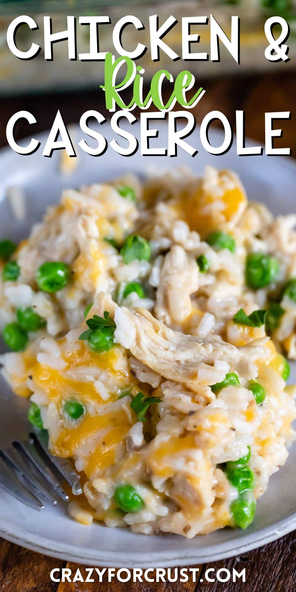 chicken and rice casserole on a grey plate next to a fork with words on the image.
