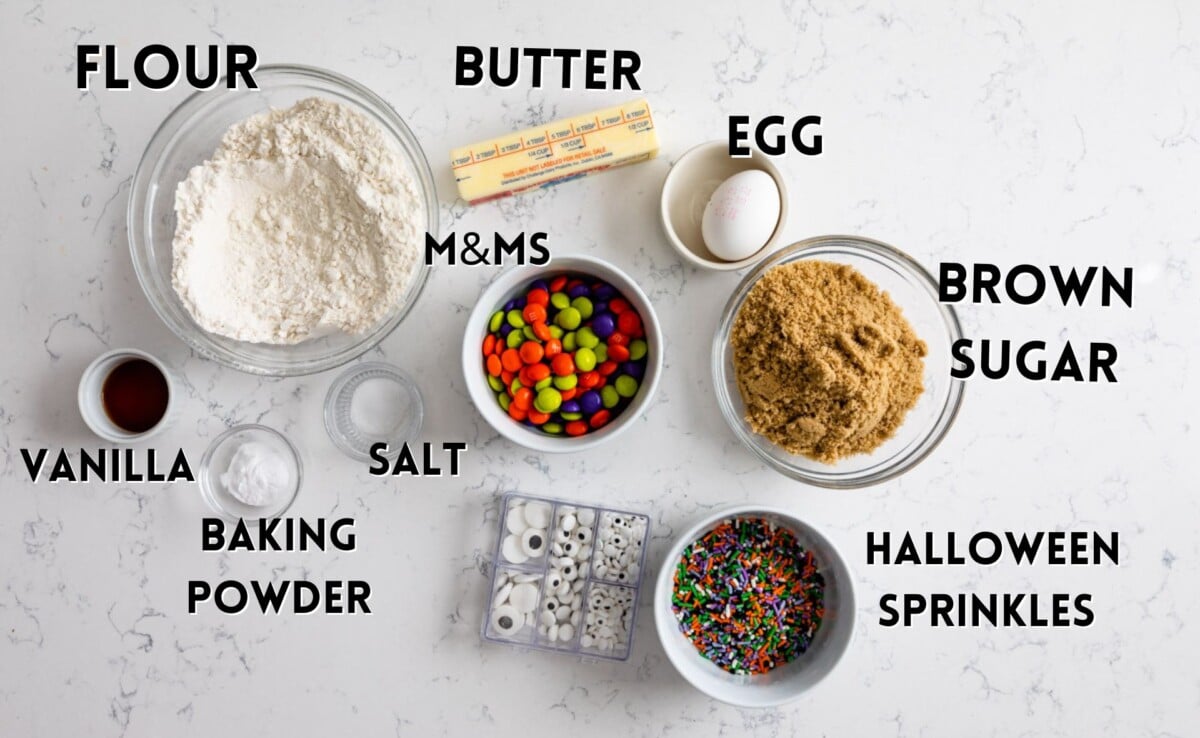 ingredients in Halloween cookies laid out on a marble counter.