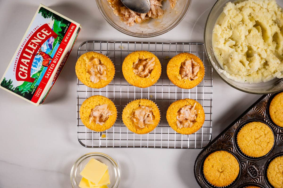 6 cupcakes on a rack with chicken inside and butter box and ingredients around.