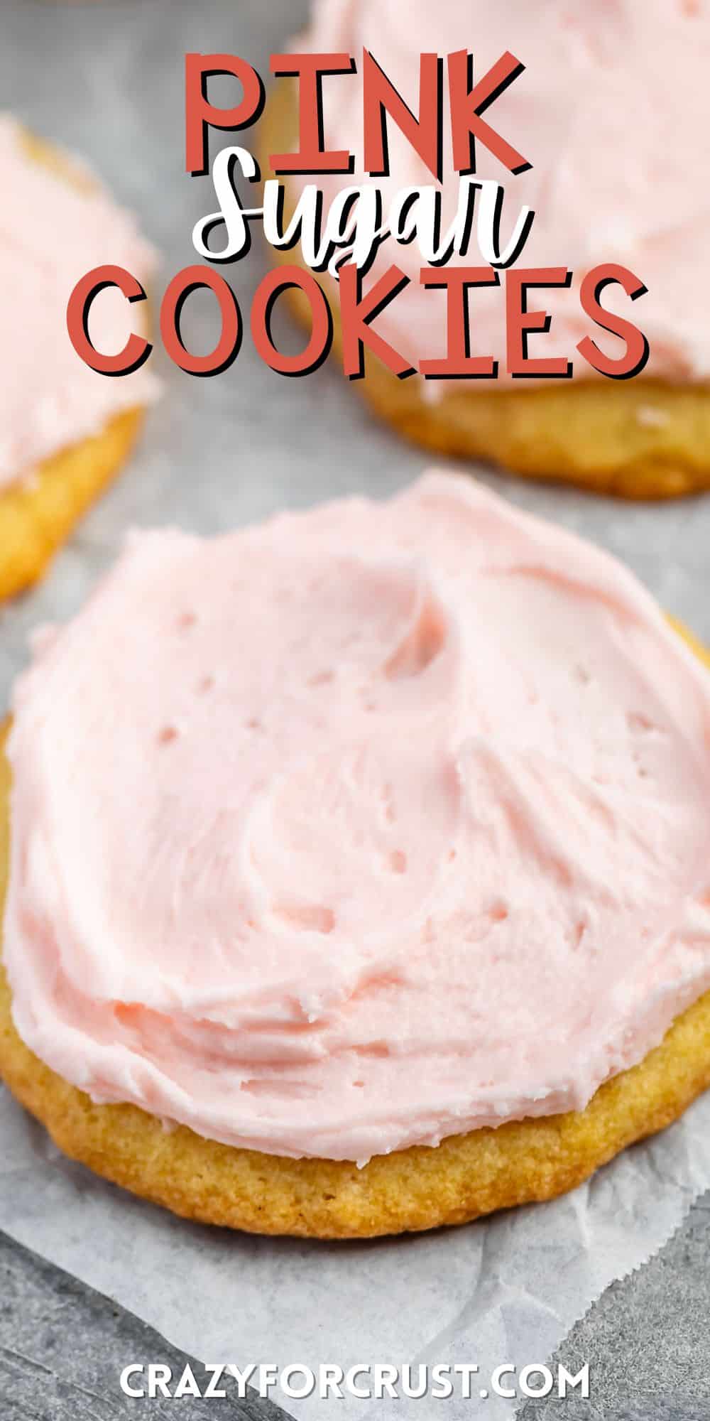 stacked yellow sugar cookies with pink frosting on top with words on the image.