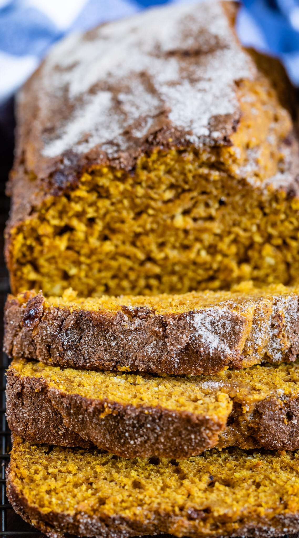 sliced pumpkin bread with powdered sugar on top.