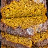 sliced pumpkin bread with powdered sugar on top.