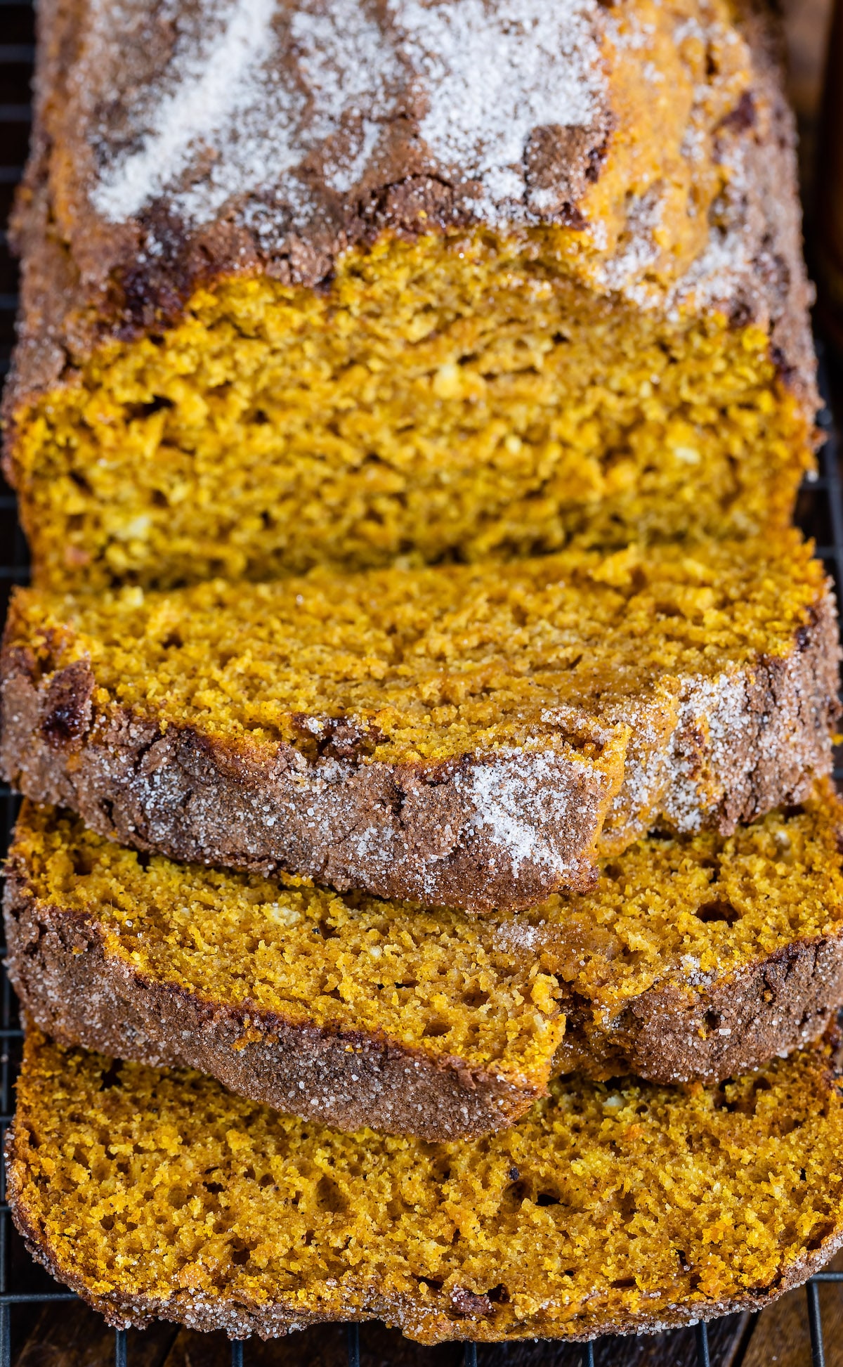 sliced pumpkin bread with powdered sugar on top.