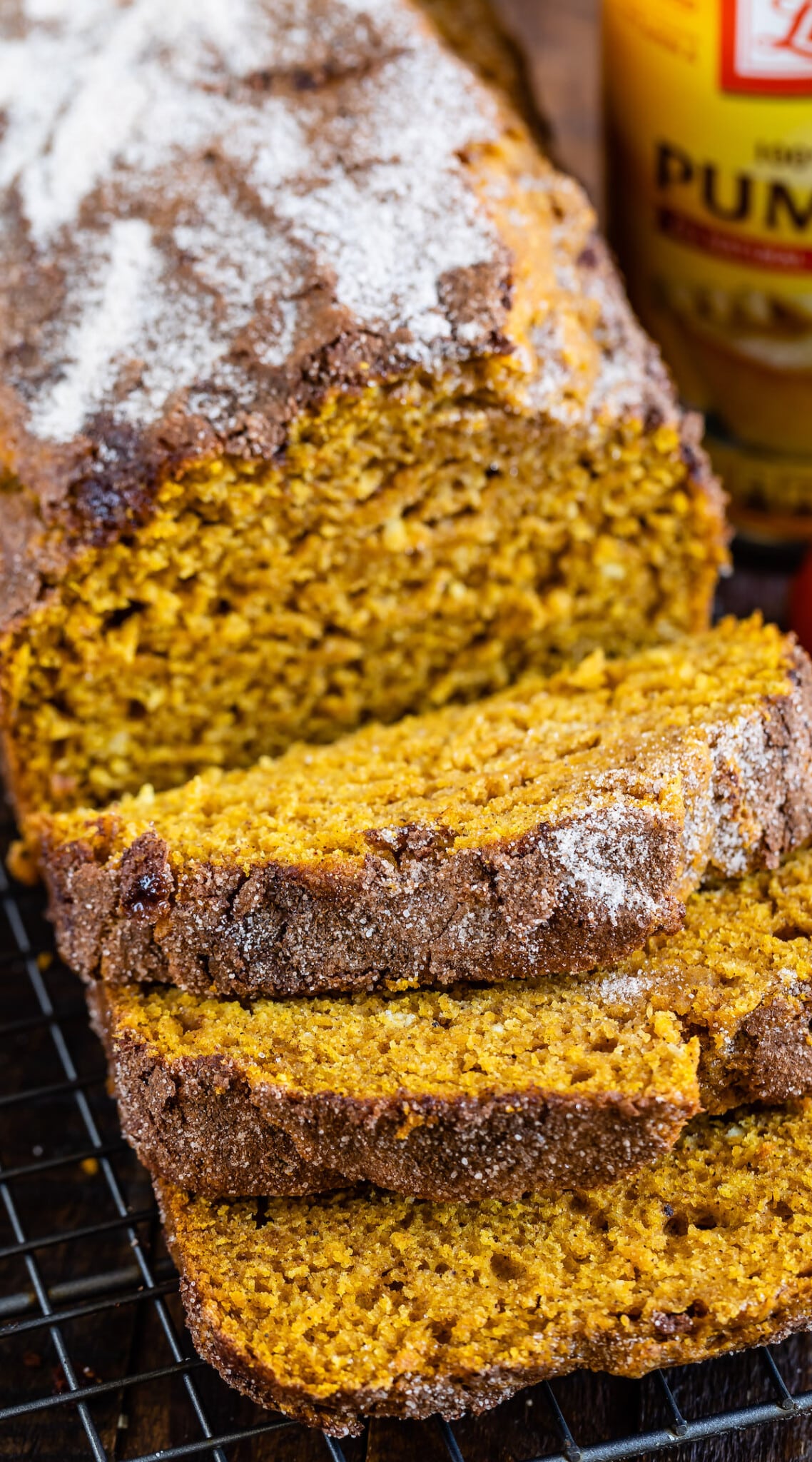 sliced pumpkin bread with powdered sugar on top.