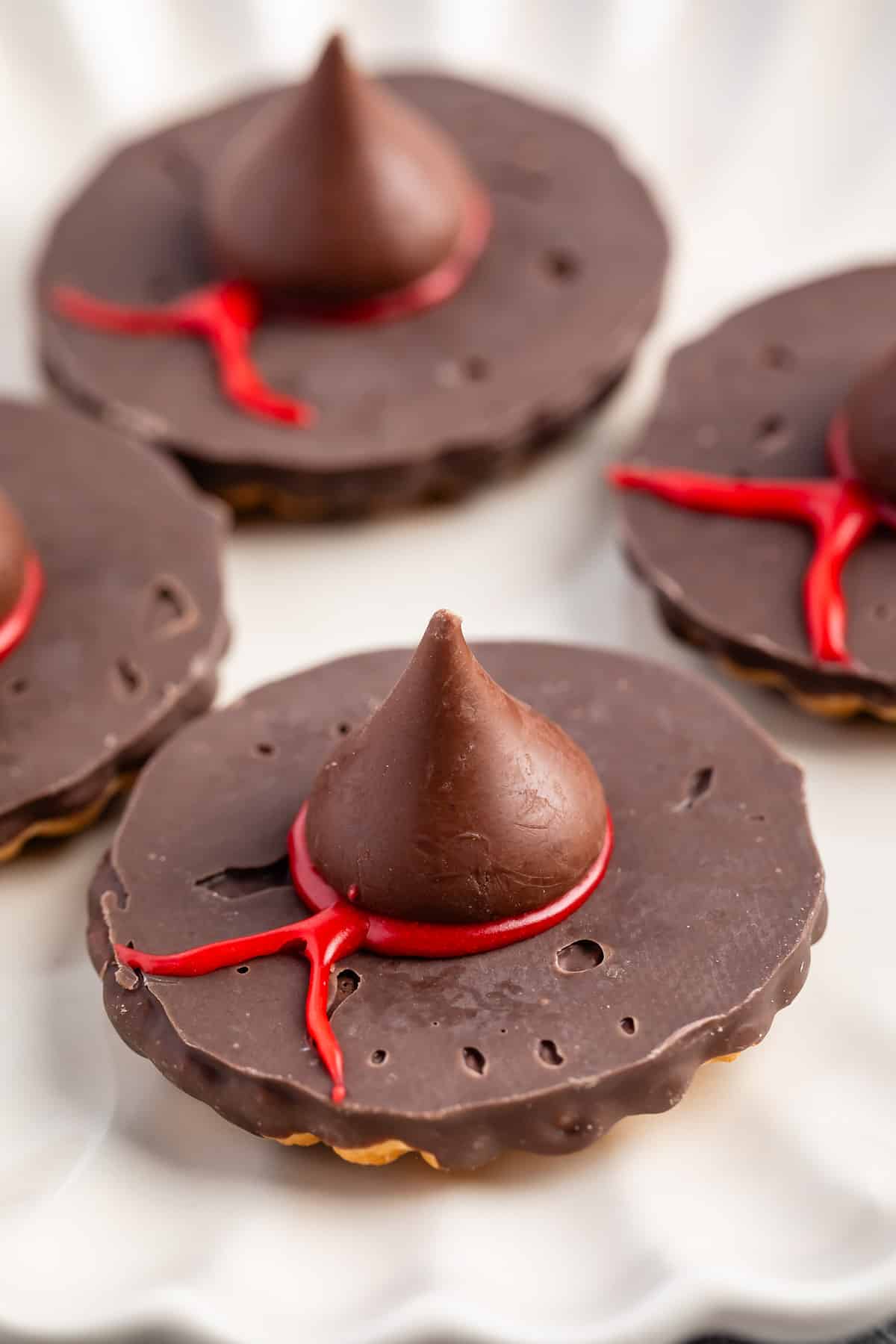 witch hats made with chocolate candy on a white plate.