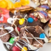 broken pieces of chocolate bark with candy attached on top.