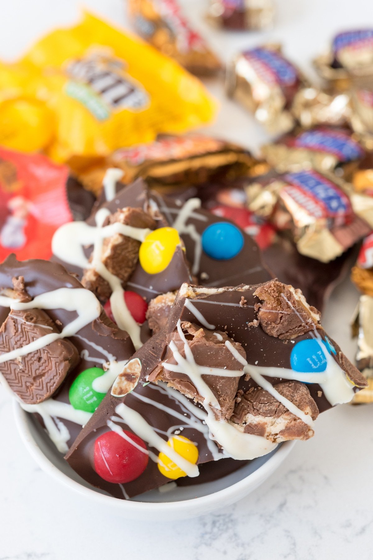 broken pieces of chocolate bark with candy attached on top.