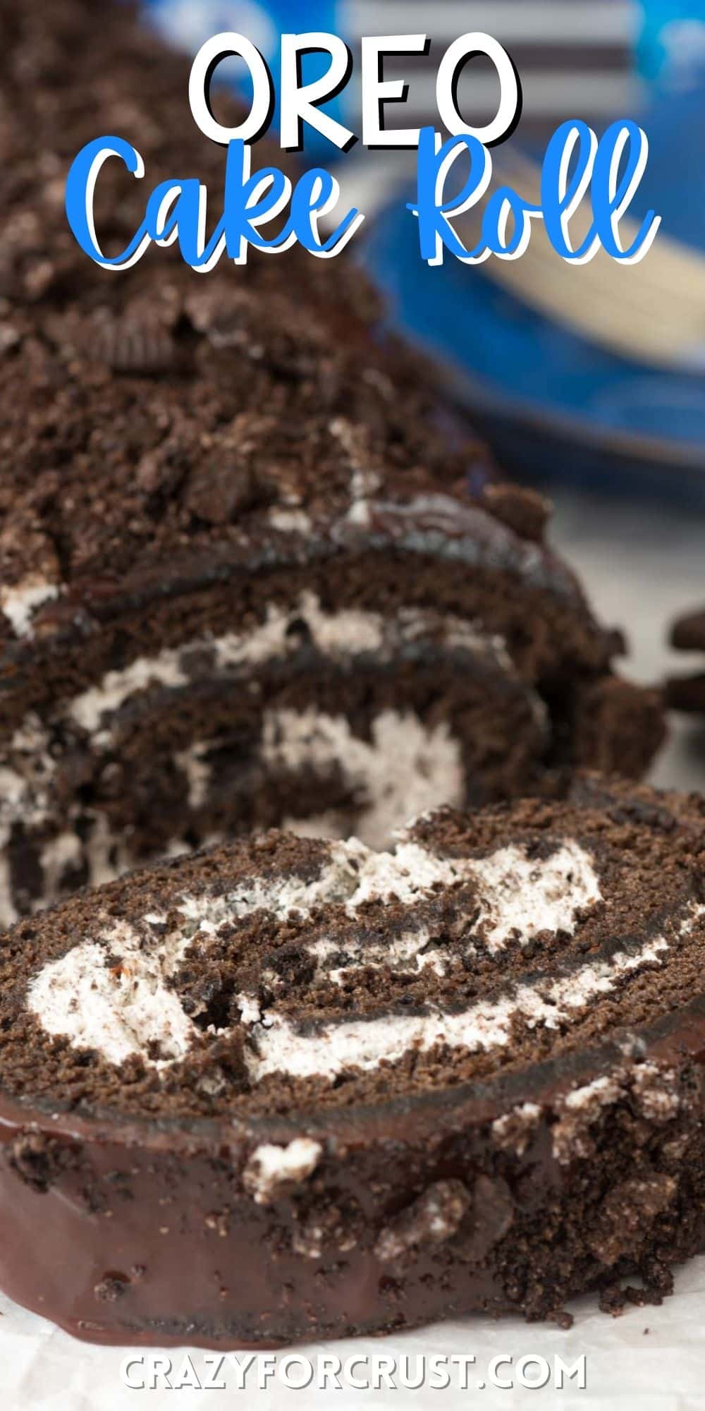 sliced Oreo cake roll thats rolled with white frosting and topped with crumbled Oreos.