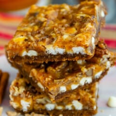 stacked pumpkin bars white white chocolate sprinkled around.