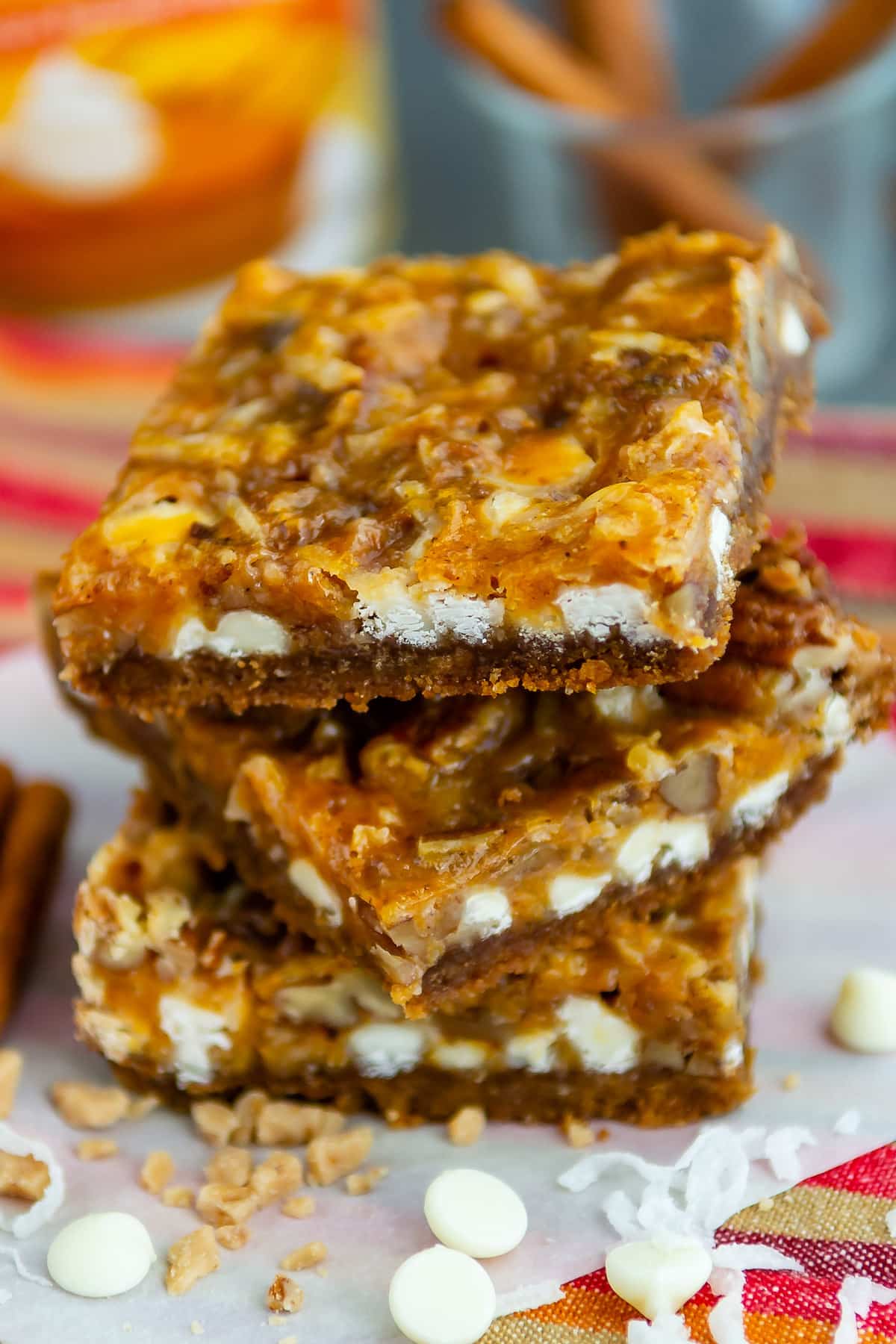 stacked pumpkin bars white white chocolate sprinkled around.