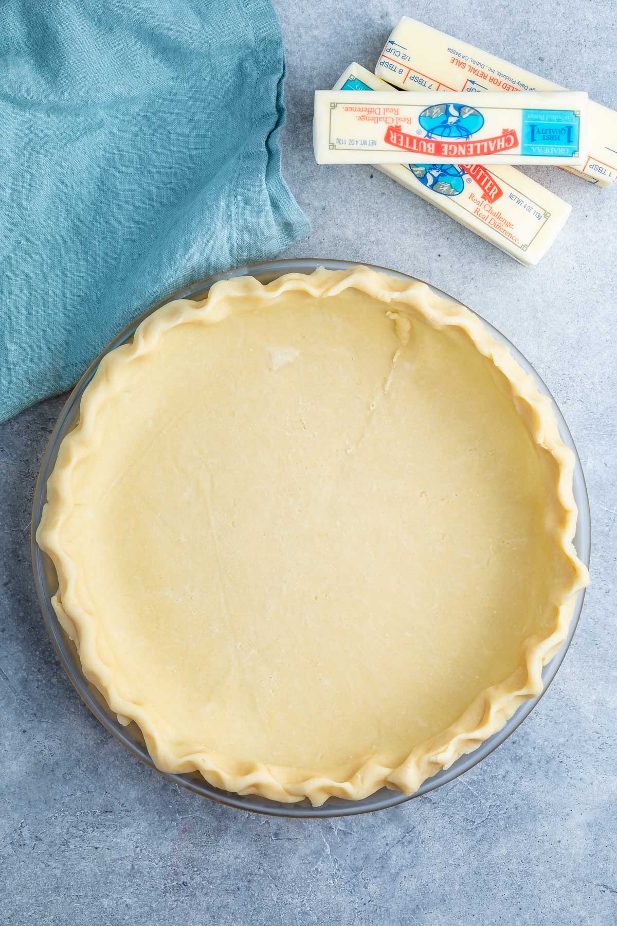 butter pie crust in a clear pan.