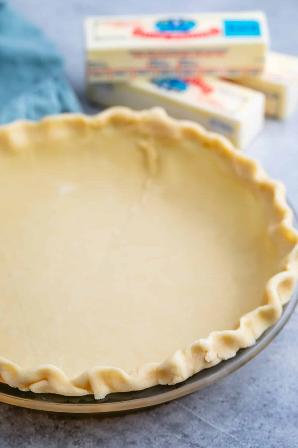 butter pie crust in a clear pan.
