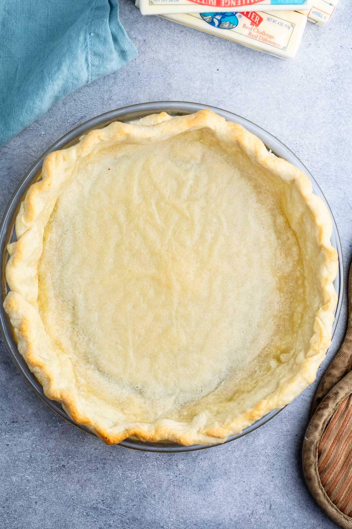 butter pie crust in a clear pan.